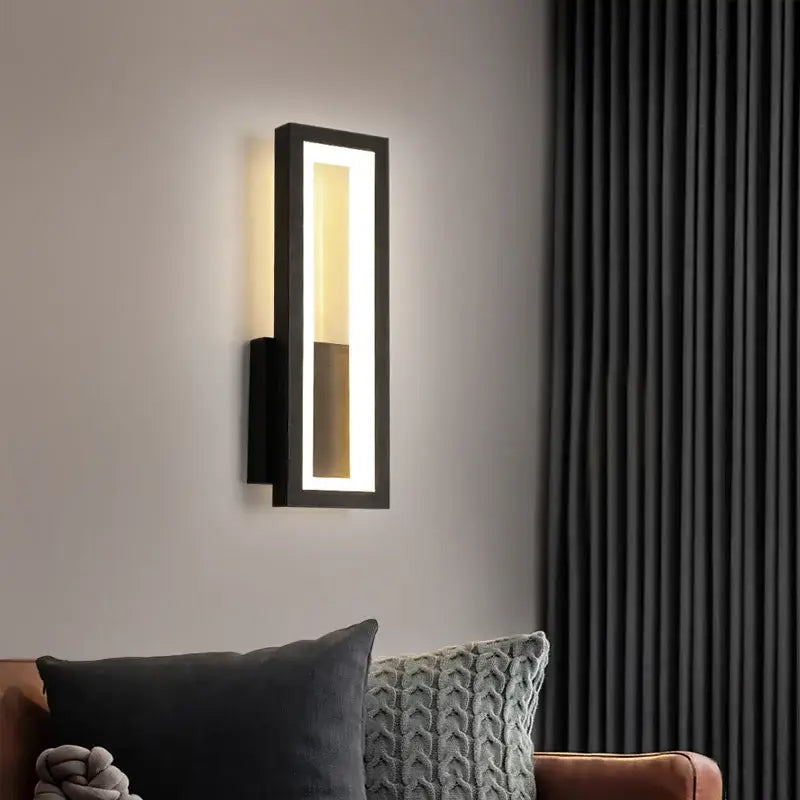 Modern black led wall sconce with vertical rectangular design and warm lighting for bedroom decor and ambient illumination