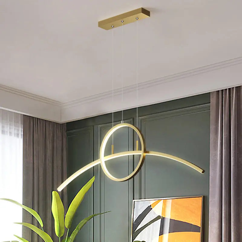 Modern gold-toned metal hanging led light fixture with sleek linear design featuring intersecting circular elements for dining room