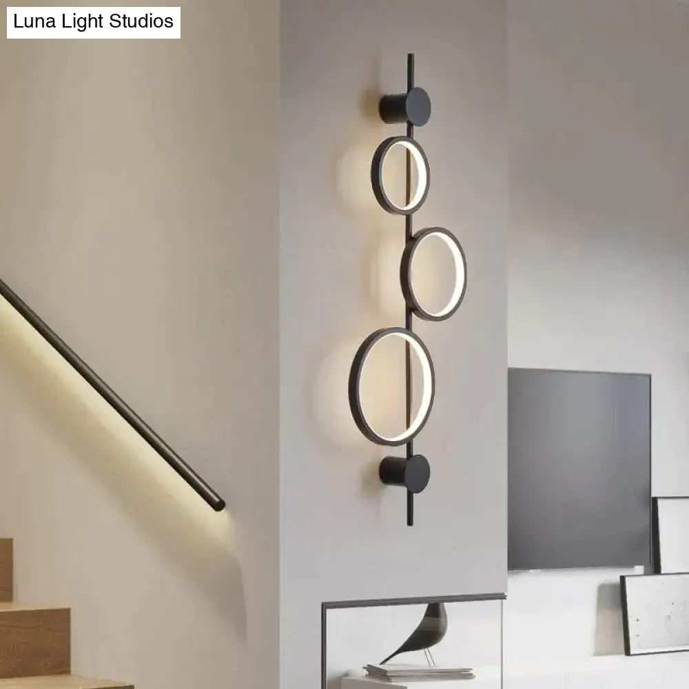 Modern black circular wall sconce with illuminated rings and matte finish for nordic linear long led living room use