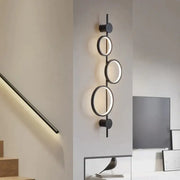 Modern black circular wall sconce with illuminated rings featuring minimalist design for nordic linear long led wall use