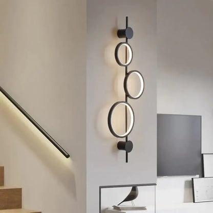 Modern black circular wall sconce with illuminated rings featuring minimalist design for nordic linear long led wall use