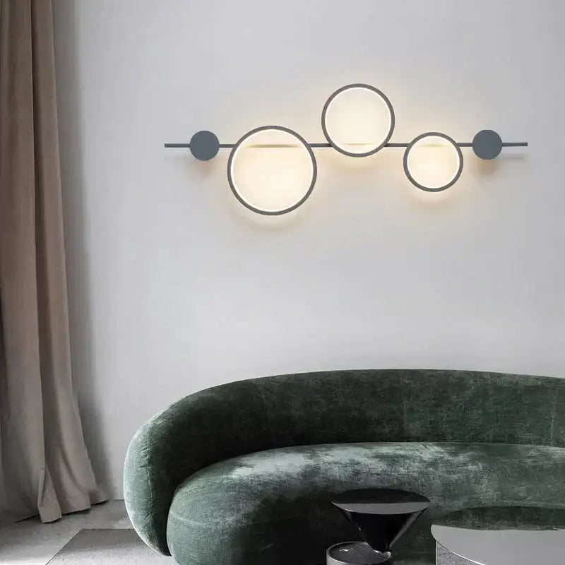 Modern black linear long led wall light with three glowing circular lights and dark gray metallic nordic linear long accents