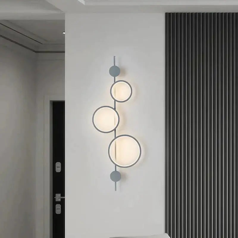 Modern black linear long led wall light with three glowing circular lights and matte gray spherical accents for living room
