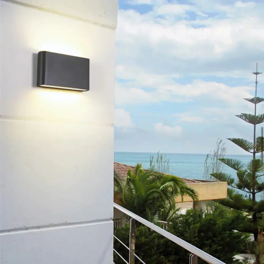 Modern black luna outdoor wall light with rectangular design emitting warm led glow for patio illumination