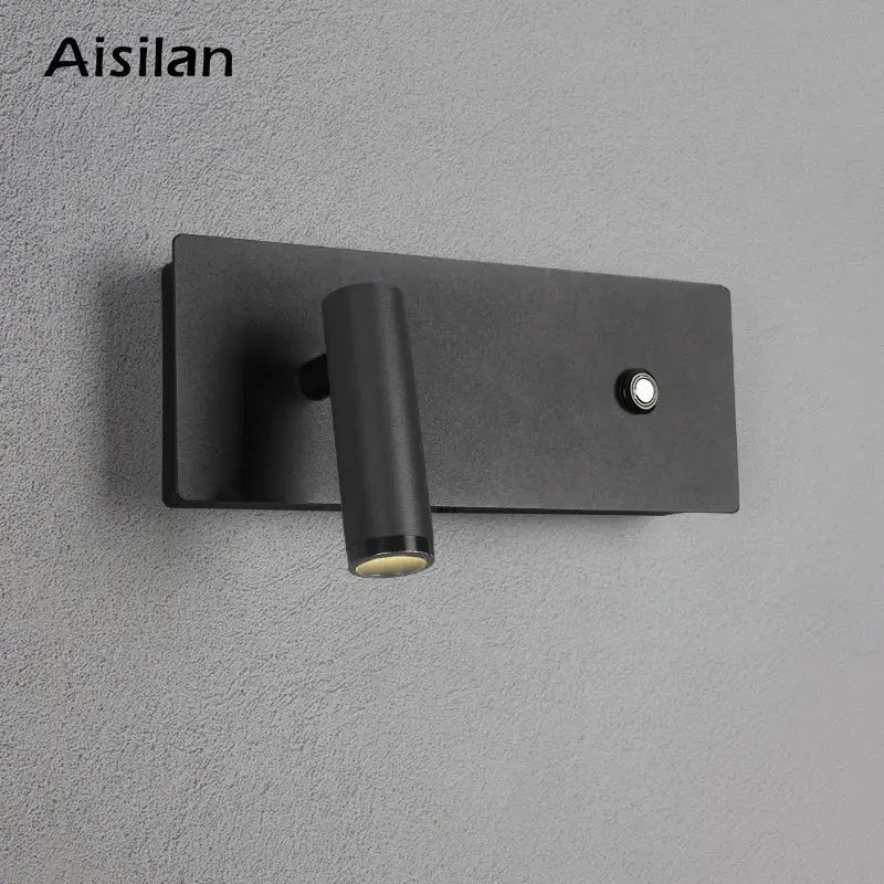 Modern black matte led wall sconce with cylindrical adjustable head and button on rectangular base for bedroom reading light