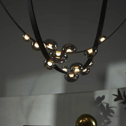 Modern black metal pendant light with spherical glass bulbs and designer leather loft style for living room decorbites
