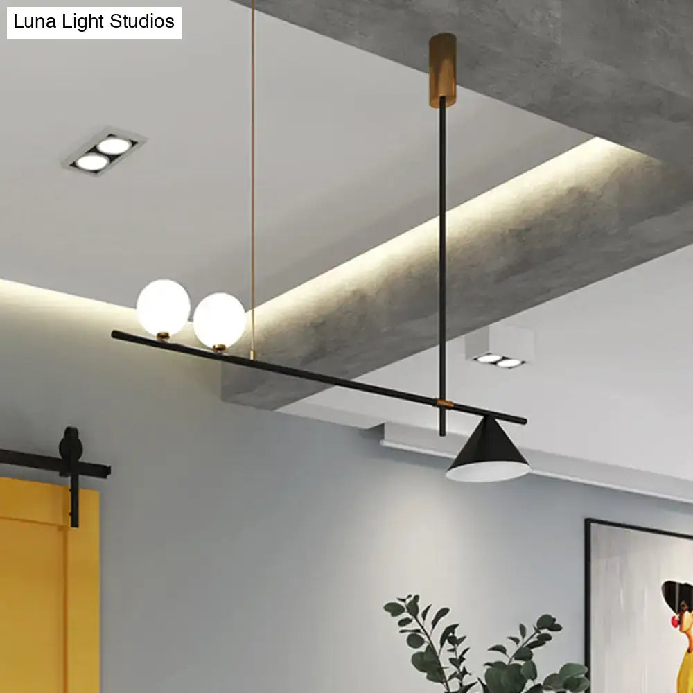 Modern black metal island lamp with opal glass shade featuring three spherical bulbs and a conical pendant light design