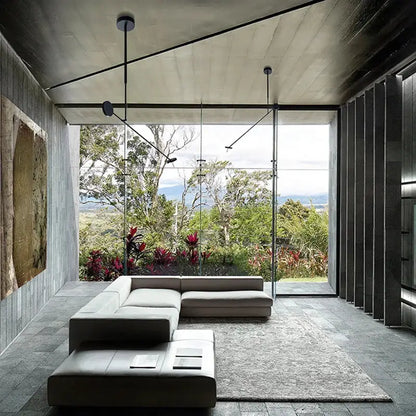 Modern minimalist sectional sofa in light gray leather paired with a decorbites black metal led chandelier for living room decor