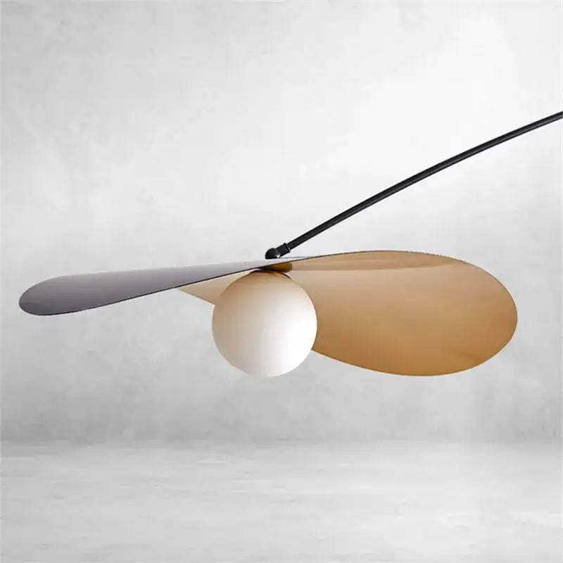 Modern black metal long arm floor lamp with sleek black and gold blade shades and central white spherical bulb decorbites adjustable long