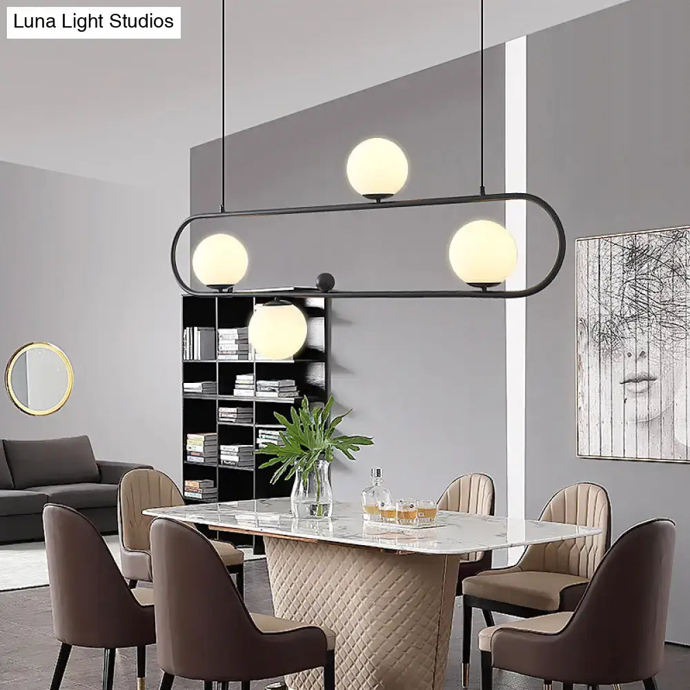 DecorBites™ minimalist black metal island light fixture with four frosted milk glass globe shades for modern spaces
