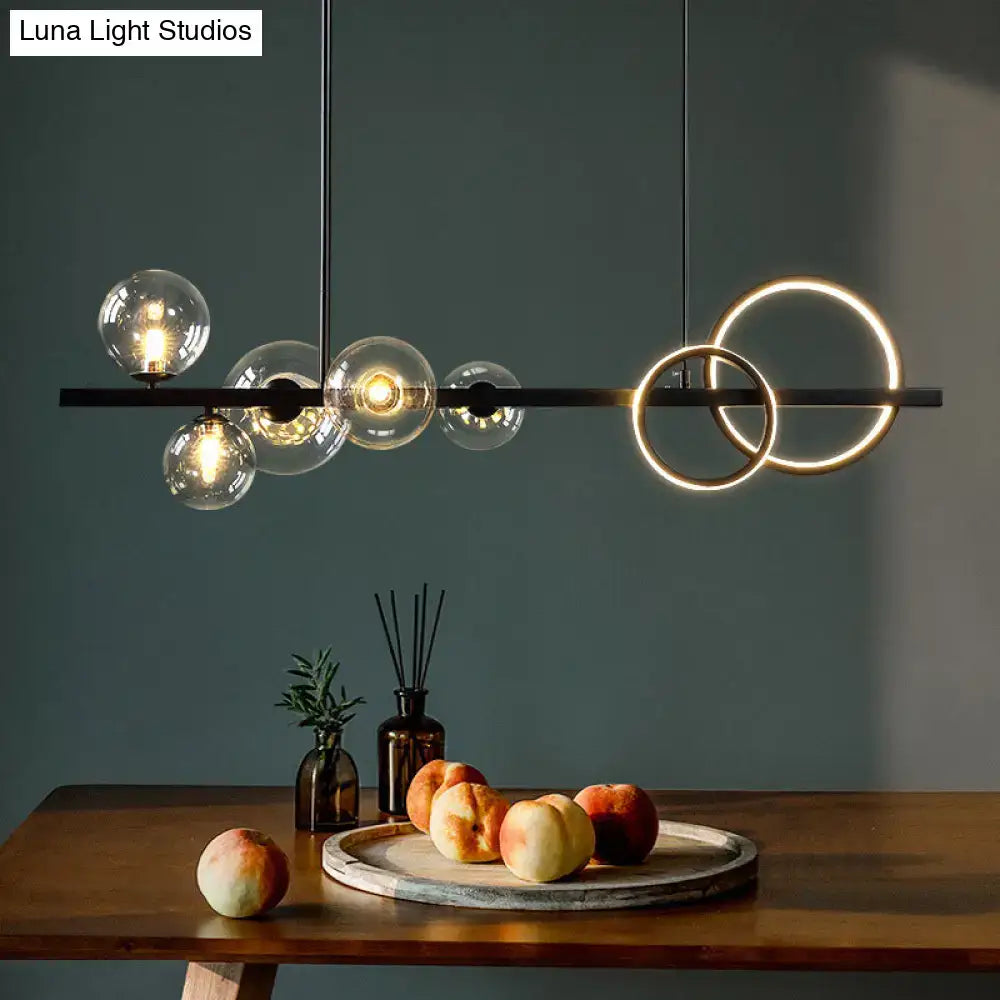 Modern black metal pendant light fixture with glowing circular rings and glass globe bulbs for dining room ceiling light