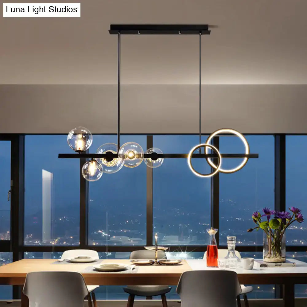 Modern black metal pendant light fixture with clear glass spheres and glowing circular rings for dining room ceiling light