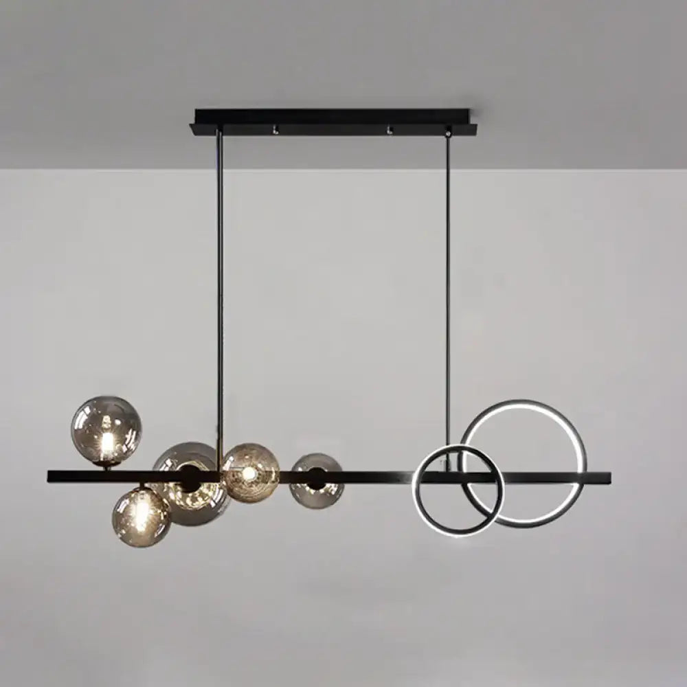 Modern black metal pendant light fixture with spherical glass elements for stylish dining room ceiling light
