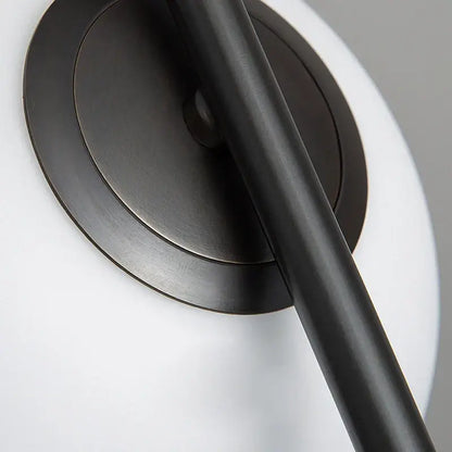 Modern black metal ring pendant light with black matte-finished cylindrical arm and circular base for dining room