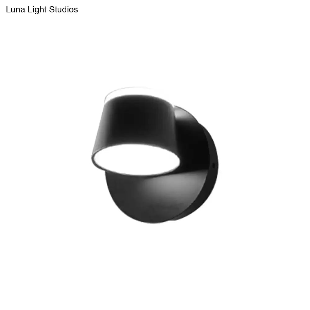Modern black metal shade wall sconce with a sleek angled cylindrical shade and compact fixture width for bedroom vanity use