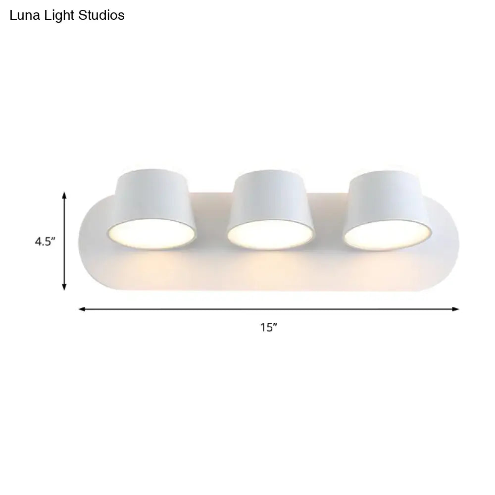 Modern black metal shade wall sconce with three sleek white cylindrical shades and smooth oval base for bedroom vanity fixture
