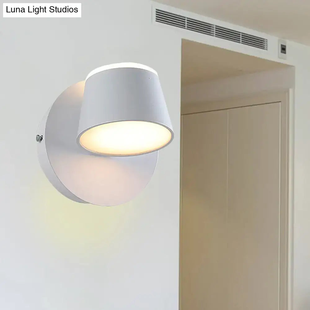 Modern black metal shade wall sconce with white cylindrical fixture and adjustable head ideal for bedroom vanity use