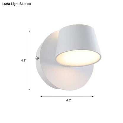 Modern black metal shade wall sconce with white cylindrical fixture and adjustable head for bedroom vanity use