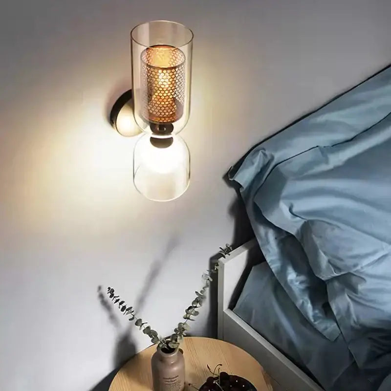 Modern black metal wall light with clear glass cylinder and amber honeycomb mesh shade for bedroom decorbites clear glass