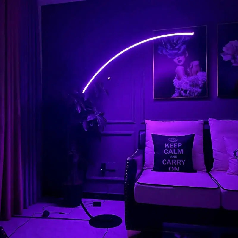 A modern black minimalist arc floor lamp with a sleek curved design emitting vibrant purple led glow