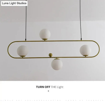 Modern black minimalist ellipse ceiling light with gold-toned metal frame and frosted white globes for living room
