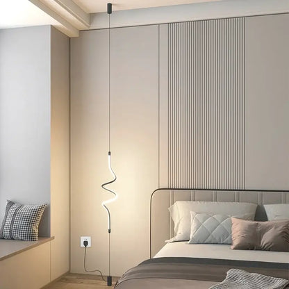 Modern black minimalist led floor lamp with curved glowing white led light suspended by thin black cords for living room