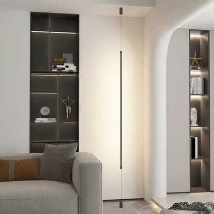 A modern black minimalist led floor lamp with a slender cylindrical body providing warm ambient lighting