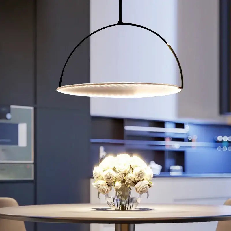 Modern black minimalist led pendant light with sleek curved metal design and warm ambient glow for living room