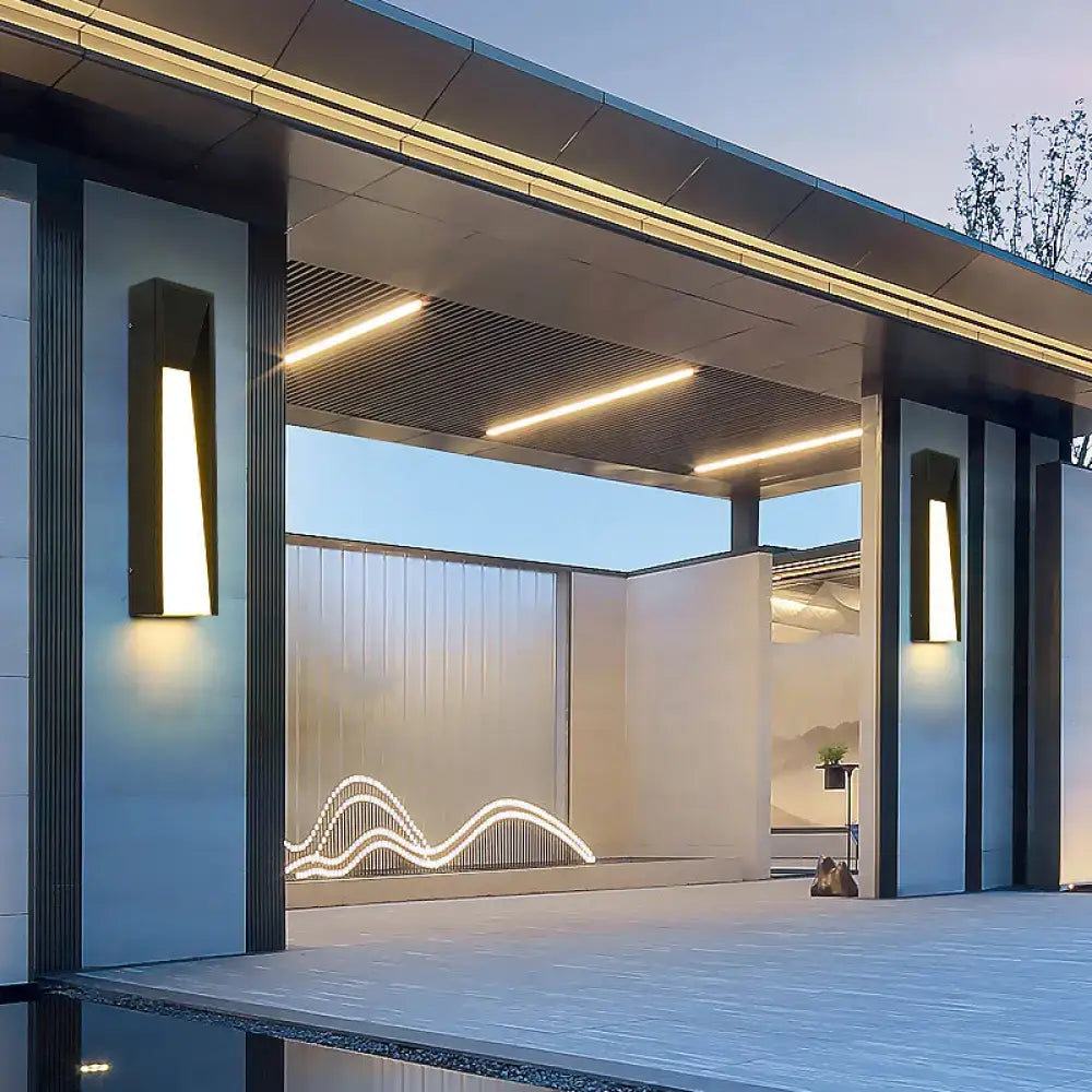 Modern black minimalist led wall light with a sleek rectangular design and warm lighting for courtyard use