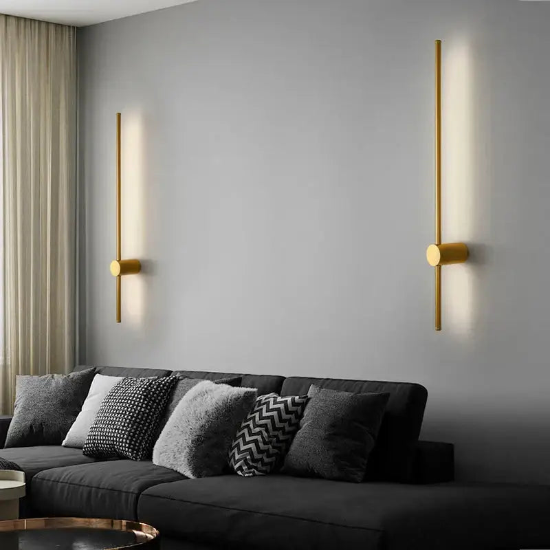 Modern black minimalist rotatable led wall lights with gold finish cylindrical bodies and warm linear light emission