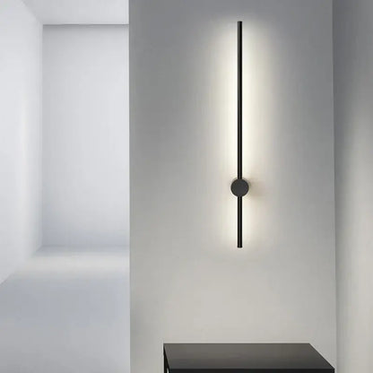 Modern black minimalist rotatable led wall light with sleek vertical rod and circular base emitting soft ambient light