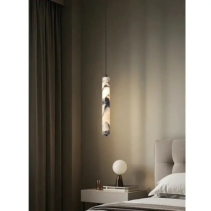 A sleek black and white natural marble stone pendant light with a cylindrical design for modern kitchens