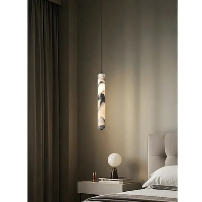 A sleek black and white natural marble stone pendant light with a cylindrical design for modern kitchens