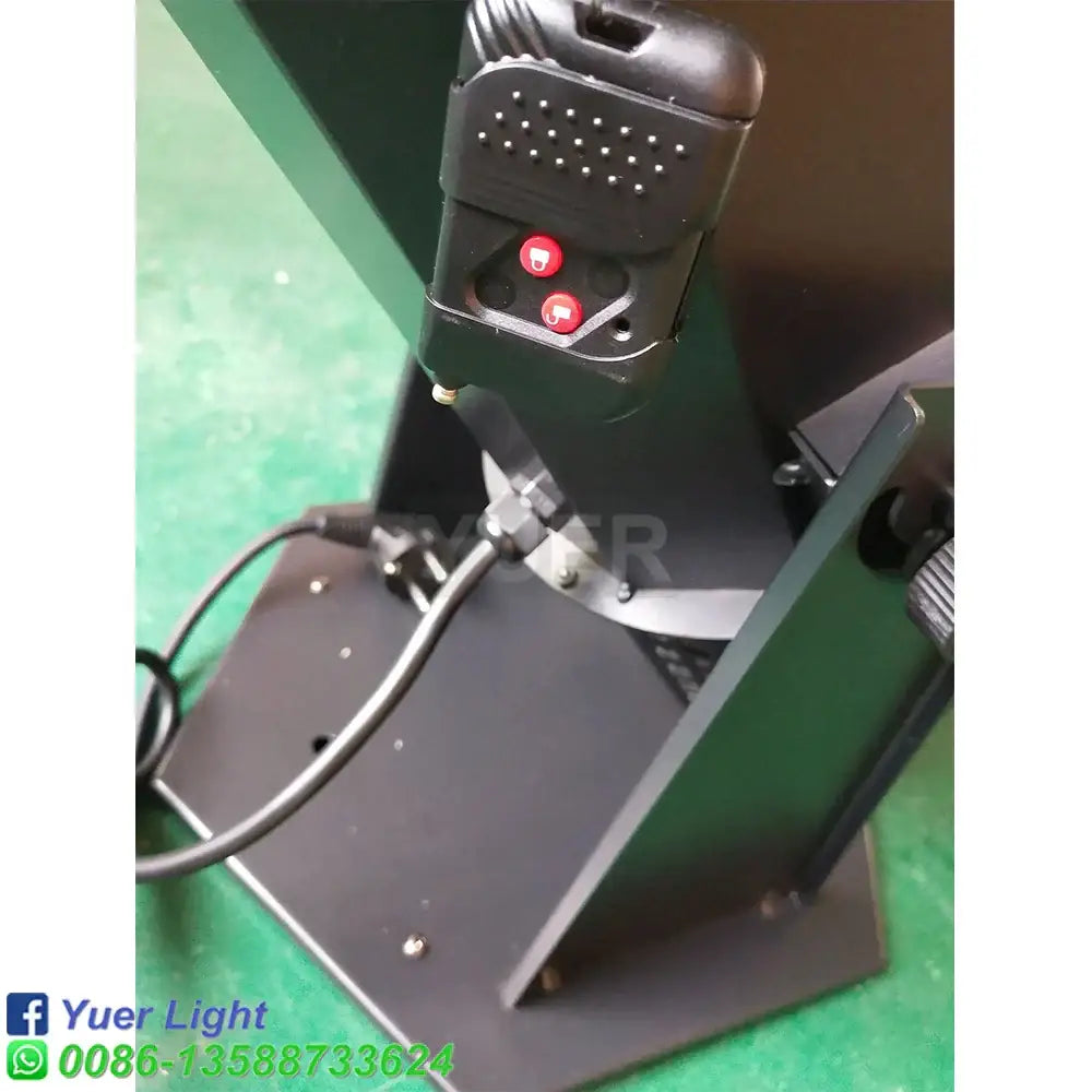 Black plastic remote control with two red buttons and perforated top for modern 1500w rgb confetti cannon stage light