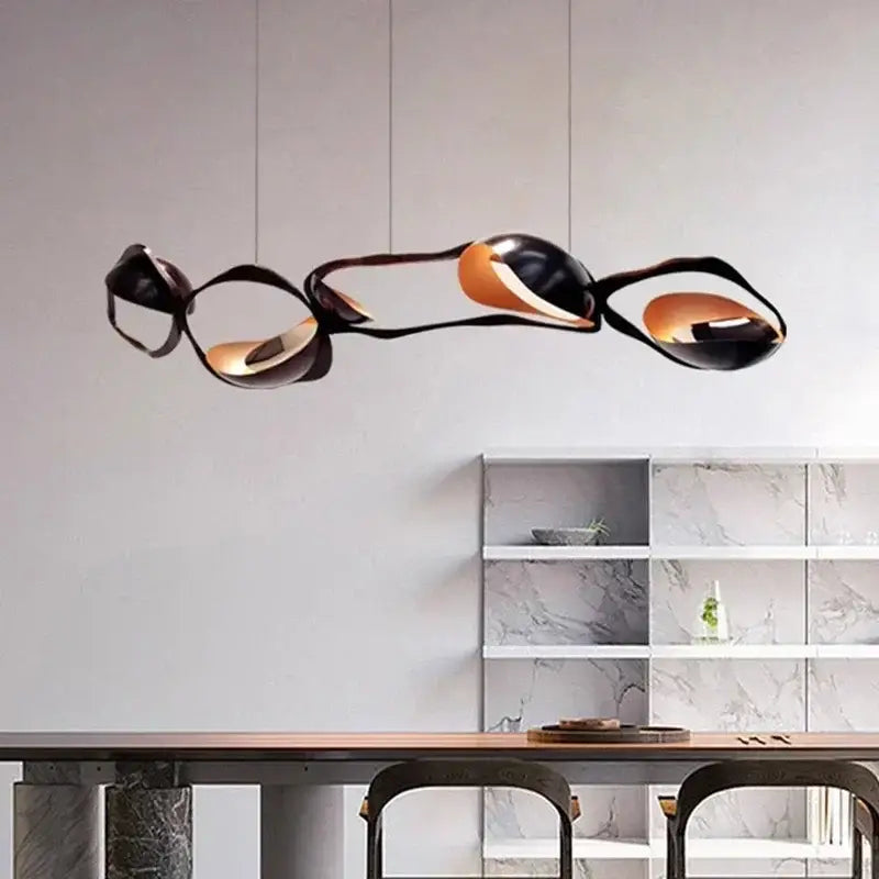 Modern black and copper-toned pendant light with sleek organic curves in painted iron selected version for dining room