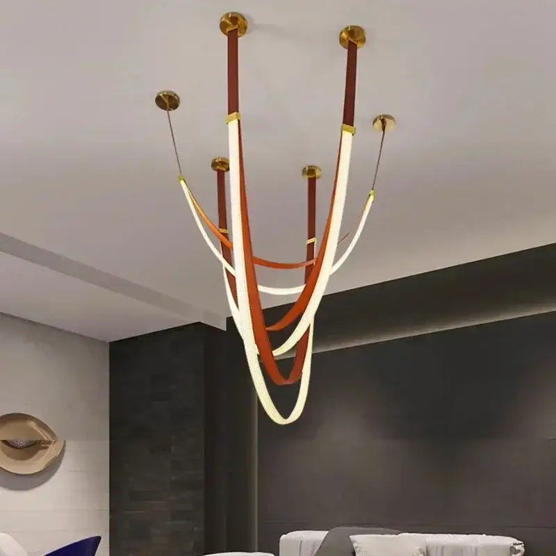 Modern black and orange leather belt pendant light with curved illuminated bands for stylish modern interiors and color options
