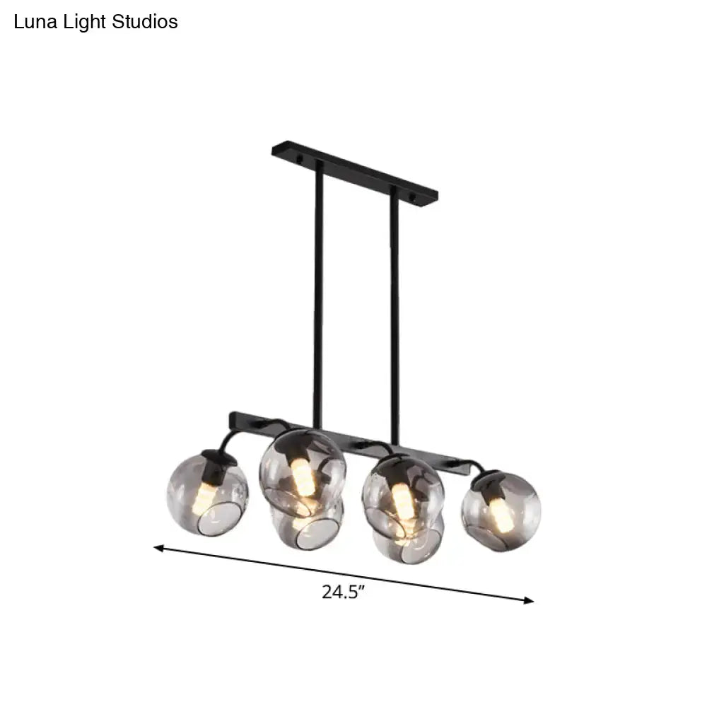 Black metal chandelier featuring four smoked glass globe shades with orb shade design for kitchen and dining room