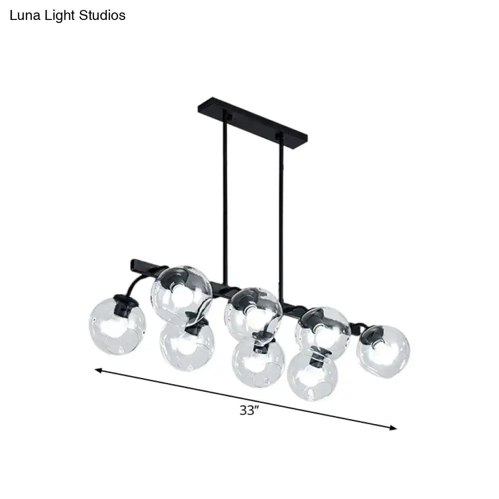 Black metal chandelier with seven clear glass globe bulbs featuring orb shade for kitchen and dining room use