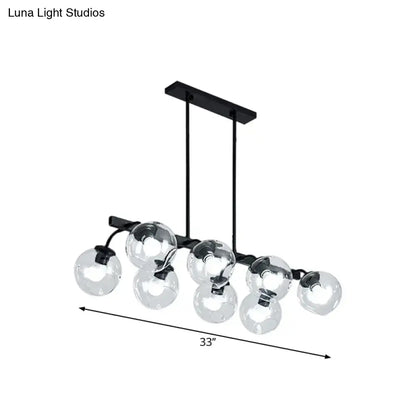Black metal chandelier with seven clear glass globe bulbs featuring orb shade for kitchen and dining room use