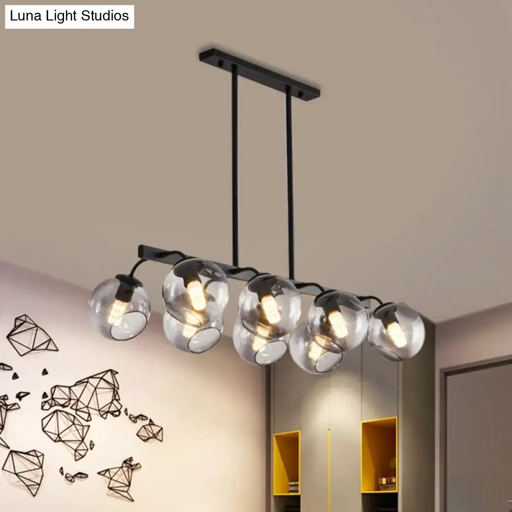Modern black metal chandelier with five clear glass globe shades featuring orb shade for kitchen and dining room