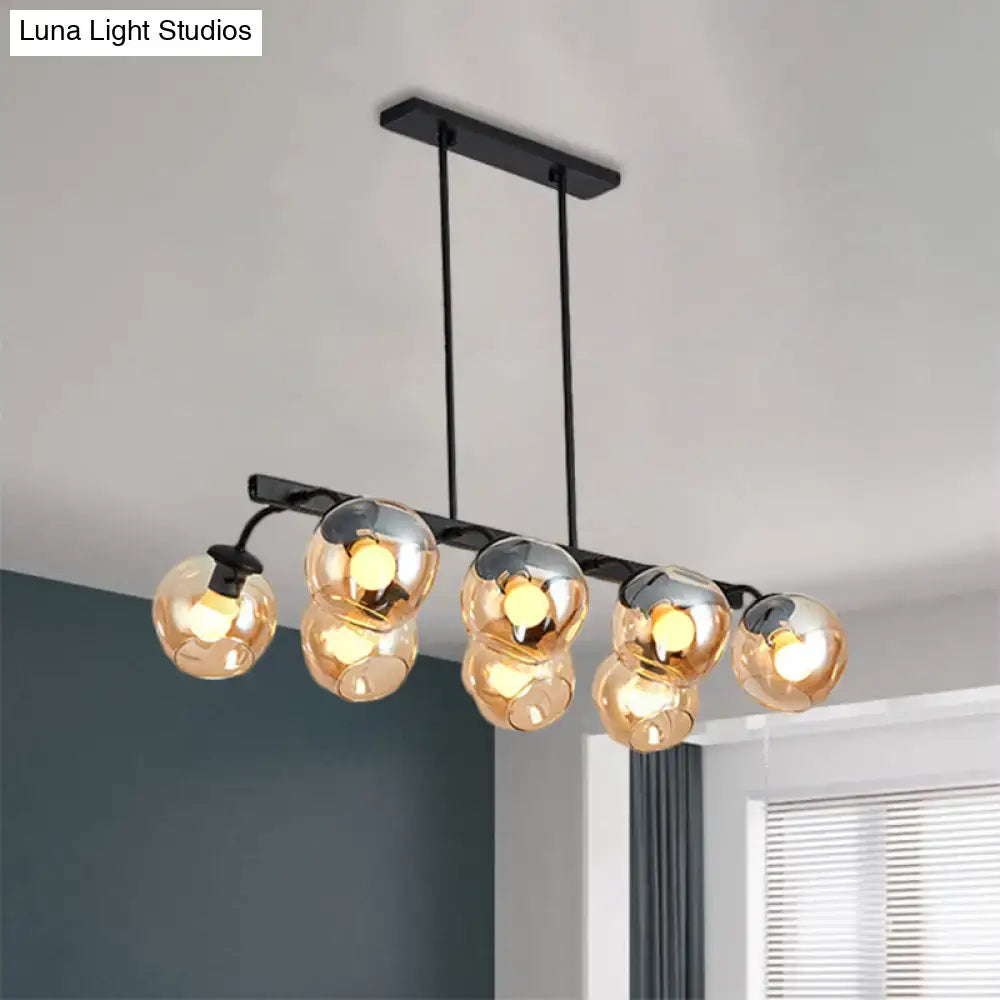 DecorBites™ modern black metal chandelier with five amber tinted glass globes and black orb shade for dining room