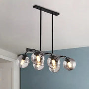 Modern black metal chandelier with four spherical smoked glass orb shade globes for kitchen and dining room lighting