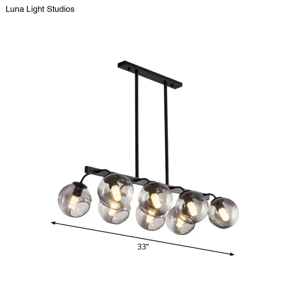 Black metal chandelier with five spherical smoked glass orb shade globes for kitchen and dining room lighting