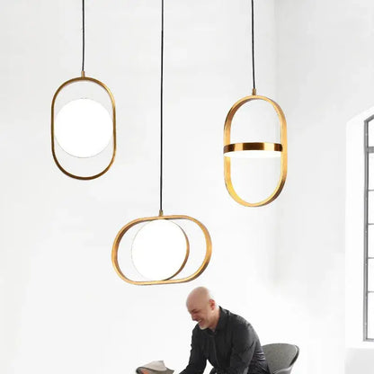 Three modern black oval adjustable angle pendant lights with gold frames and frosted glass for dining room decorbites