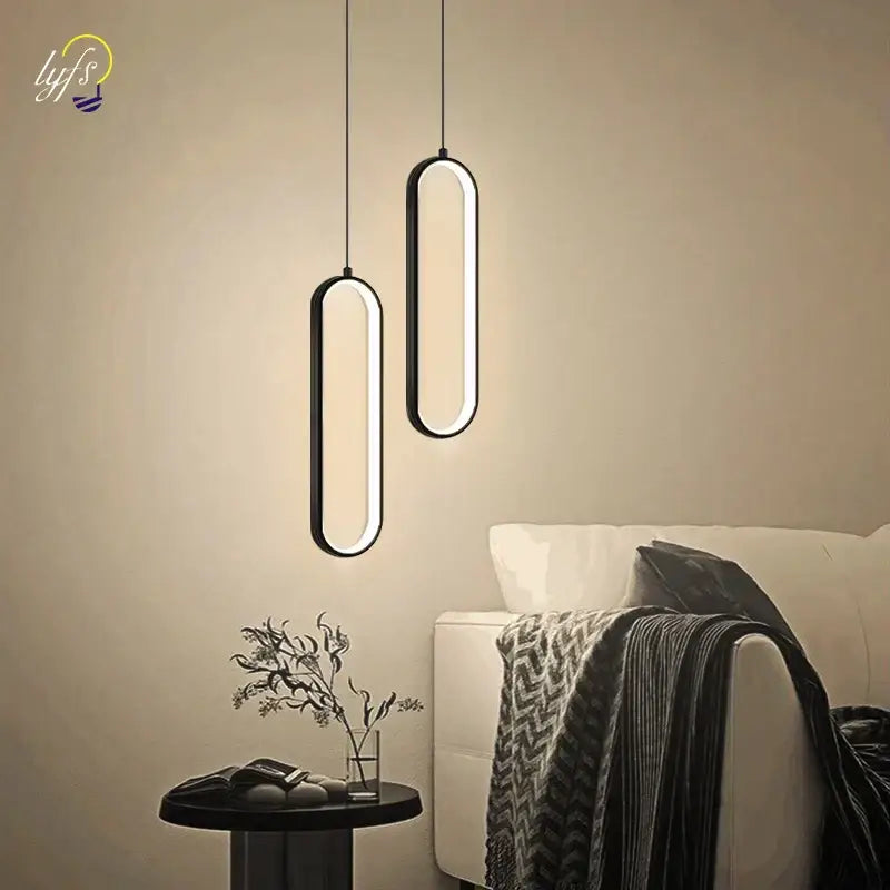 Modern black oval pendant light with black finish and glowing led bulbs ideal for dining room illumination
