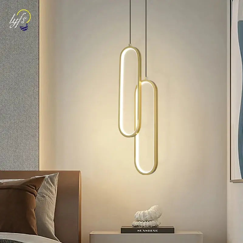 Modern black oval pendant light with led bulbs and gold-toned sleek design providing warm ambient glow