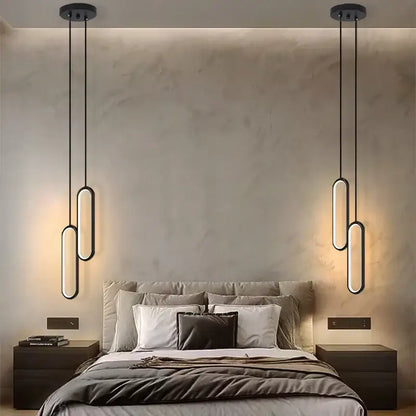 Modern black oval pendant light with black finish and led bulbs featuring sleek elongated design for dining room use