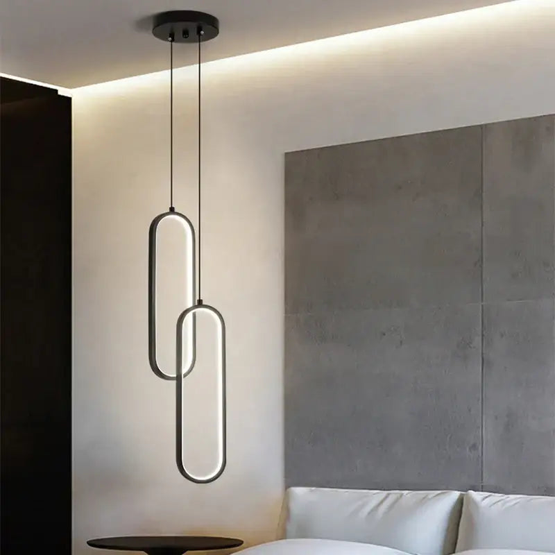 Modern black pendant light with sleek interlocking oval led rings and black finish with led bulbs for dining room use