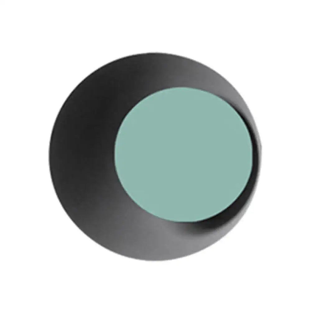 Modern black and pink circle sconce light fixture with a black circular eyeshadow palette and teal compact center