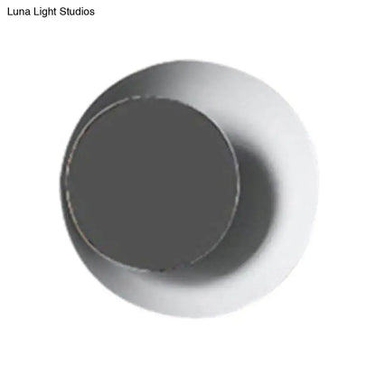 A sleek modern black and pink circle sconce light fixture with a matte dark gray inner surface and smooth white outer rim
